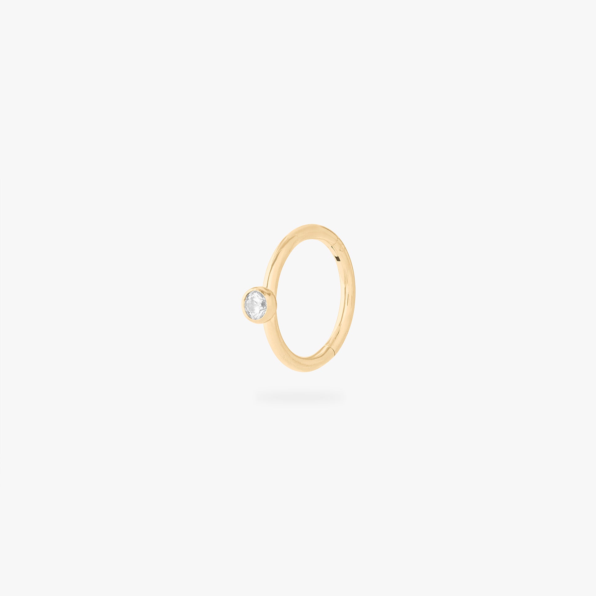 gold clicker with a cz bezel accent stone - Main view