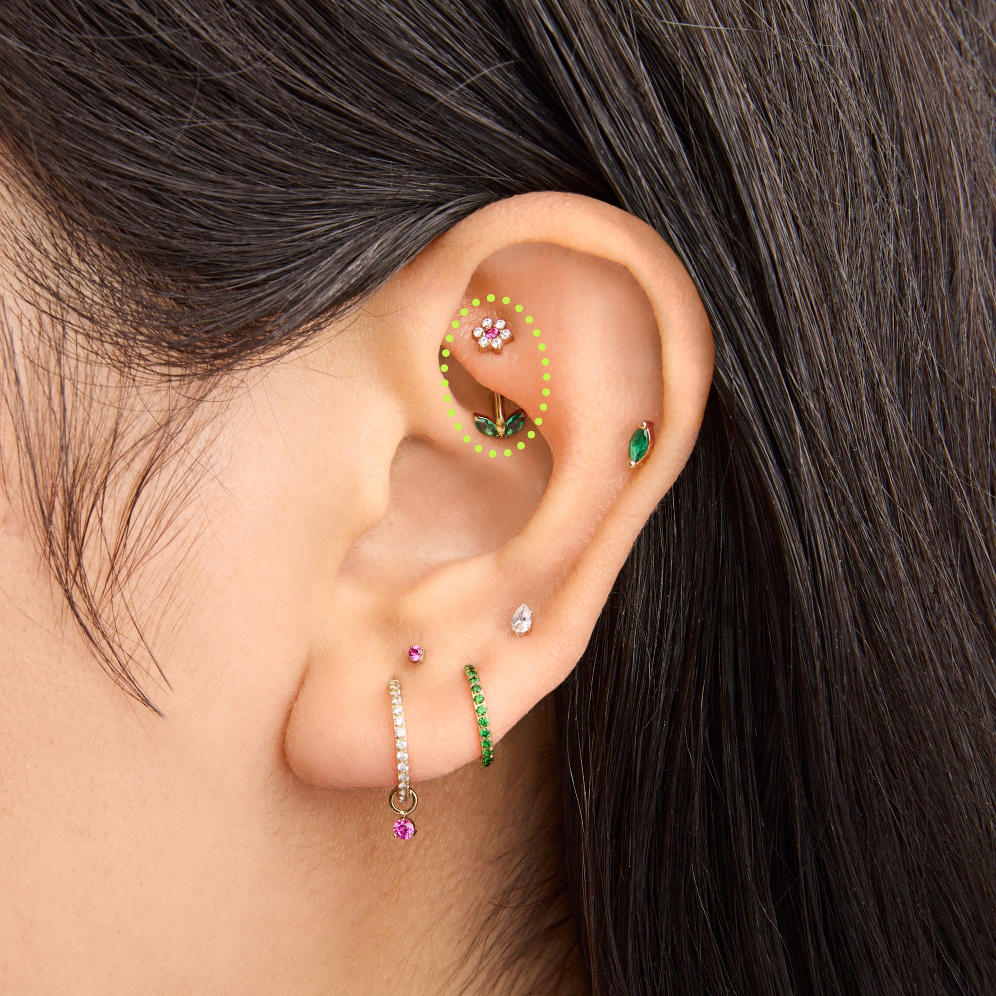 This is an image of a barbell that is shaped like a cz flower with pink cz petals and a green cz stem on ear. [hover] color:null|gold/pink
