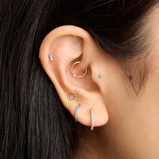 This is an image of a gold toned flatback with a flower shape of red enamel on ear. [hover] color:null|gold/red