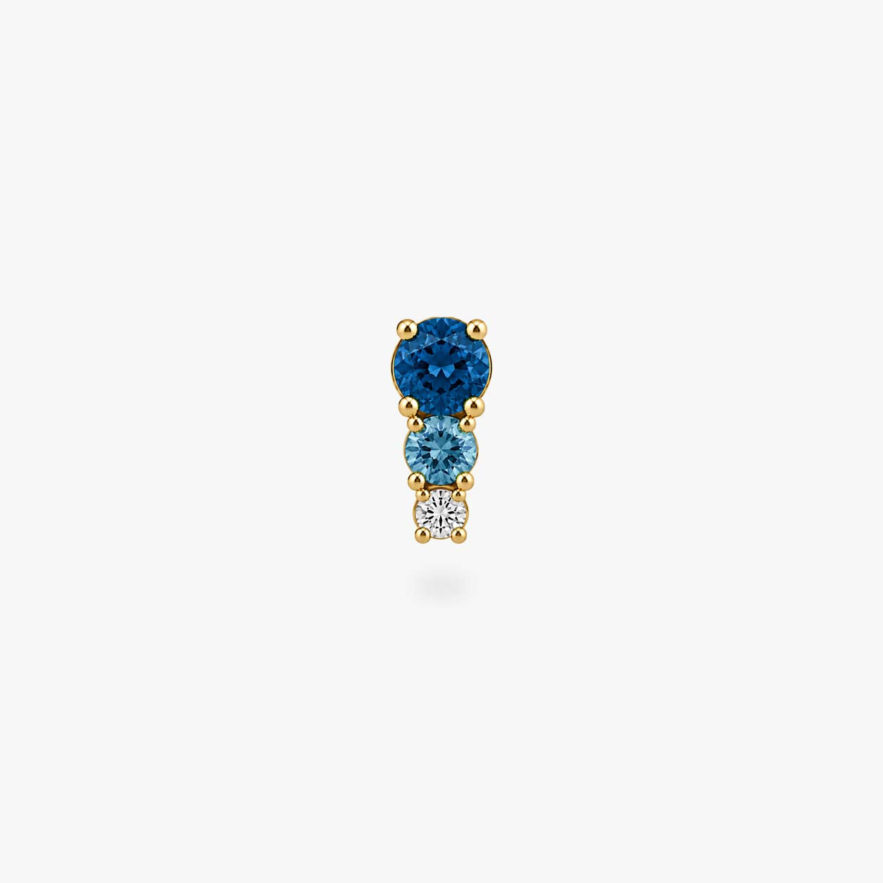 This image shows a front view of a Golden titanium flatback with three cz stones. the top one is a dark blue, the middle a light blue and the bottom cz is clear. - Alternative view 2