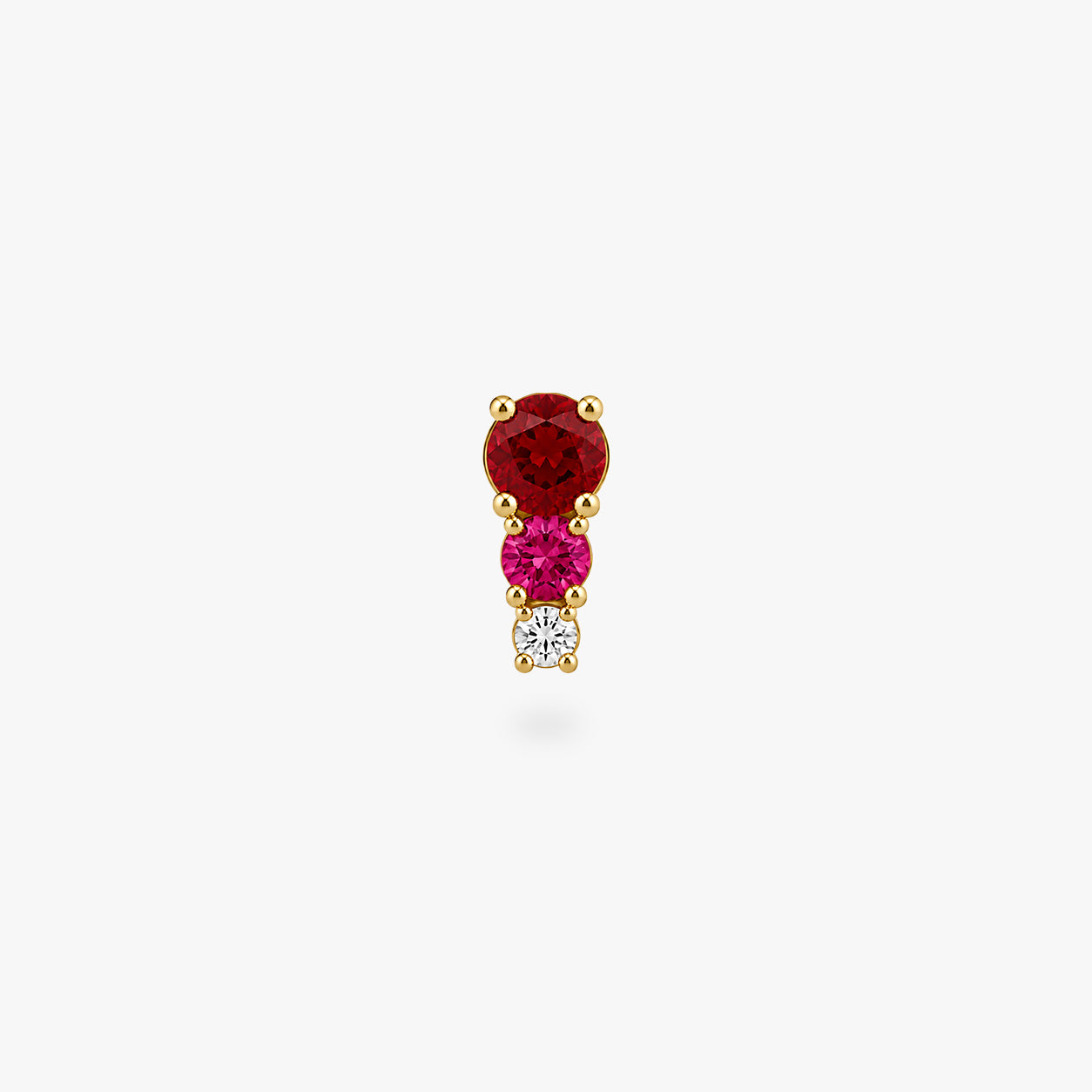 This image shows a front view of a Golden titanium flatback with three cz stones. the top one is a red, the middle is pink and the bottom cz is clear. - Alternative view 2