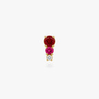 This image shows a front view of a Golden titanium flatback with three cz stones. the top one is a red, the middle is pink and the bottom cz is clear. 