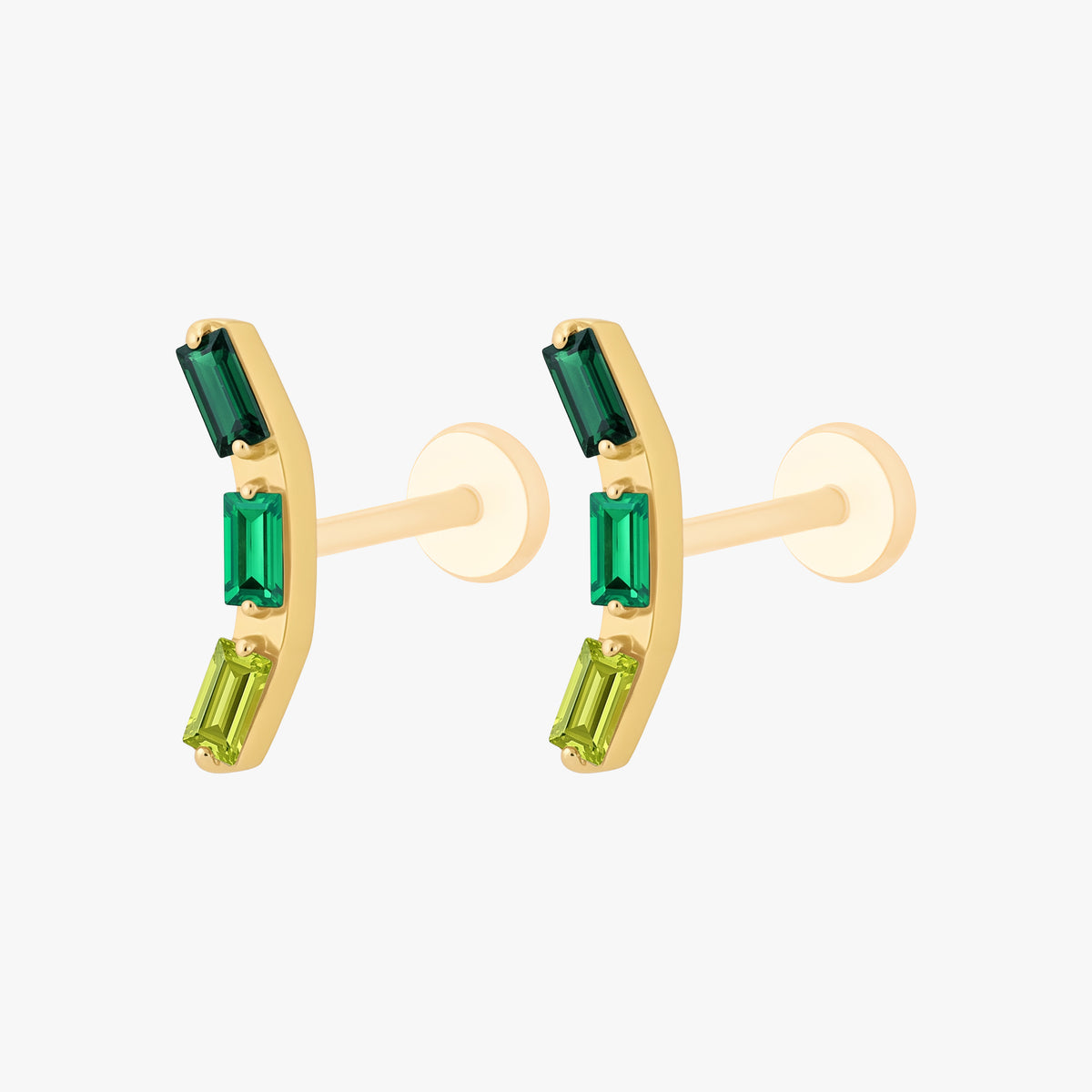 This image shows the side view of a pair of the golden titanium baguette flatback with three green cz stones 