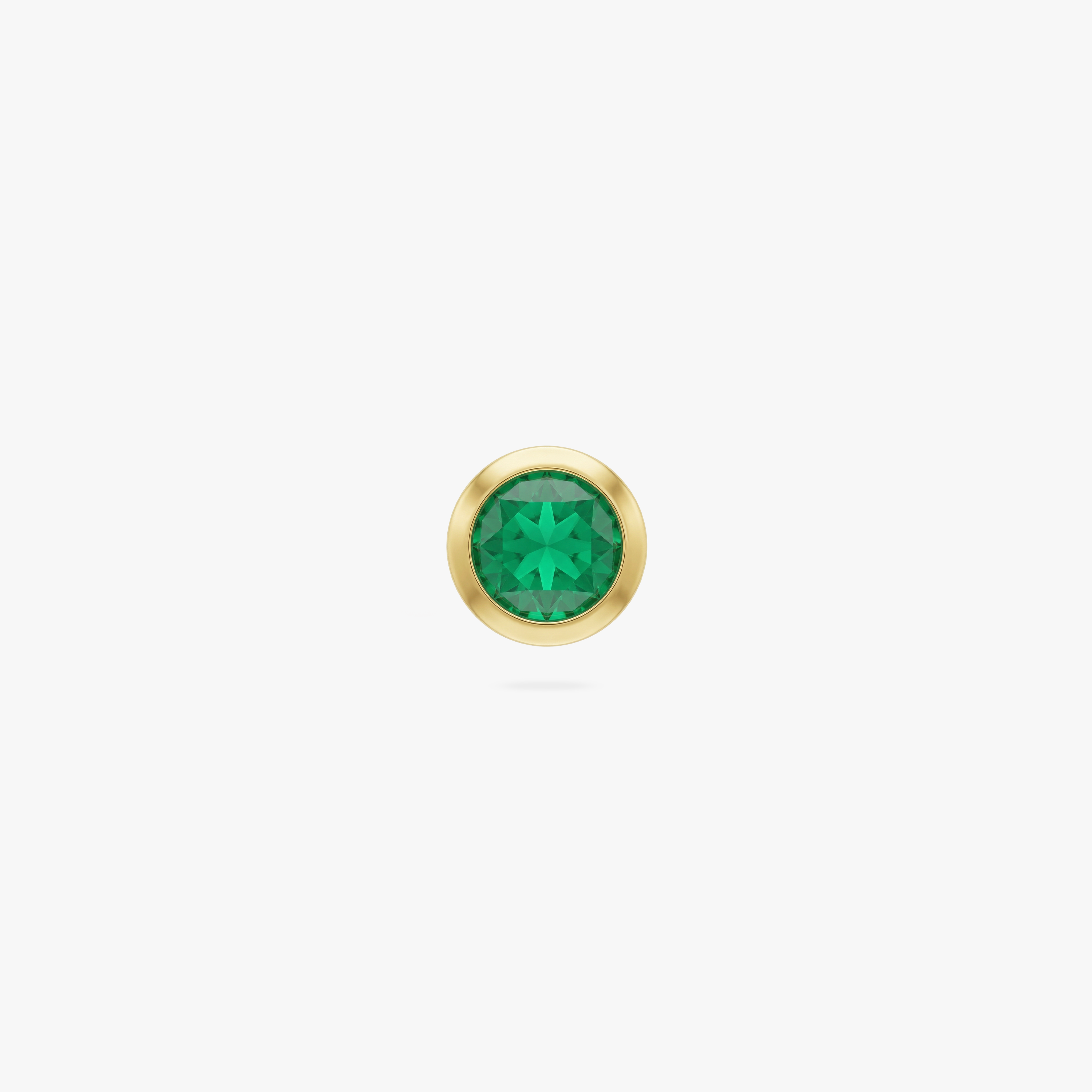 This is an image of a gold toned flatback stud with a 3mm, bezel set green CZ stone. 