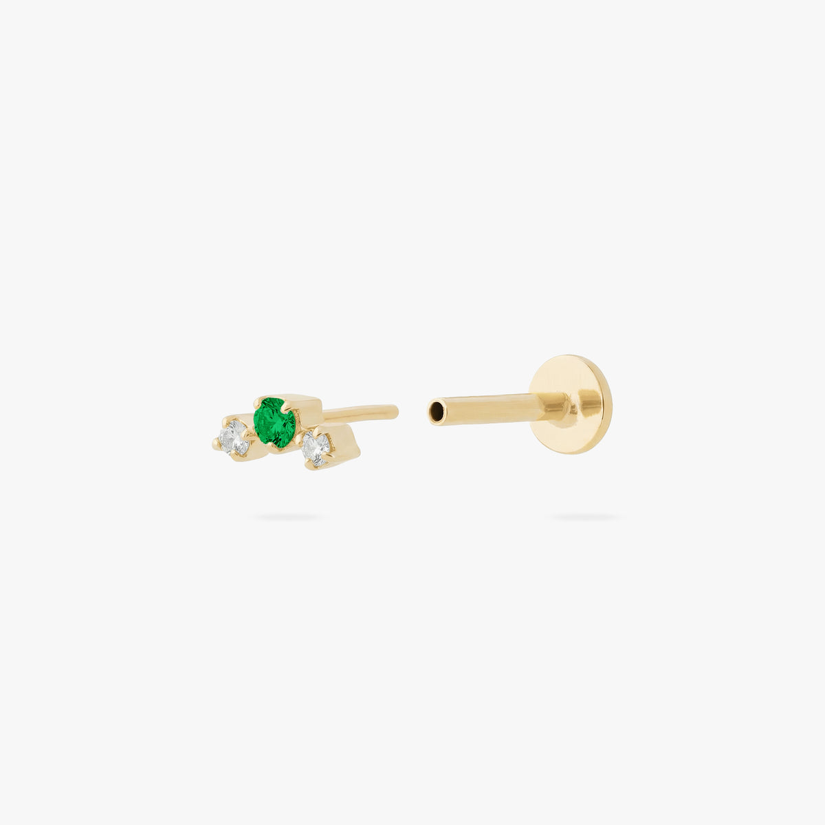 this image shows a gold plated micro cluster flatback with two clear and one green cz stones separated from labret