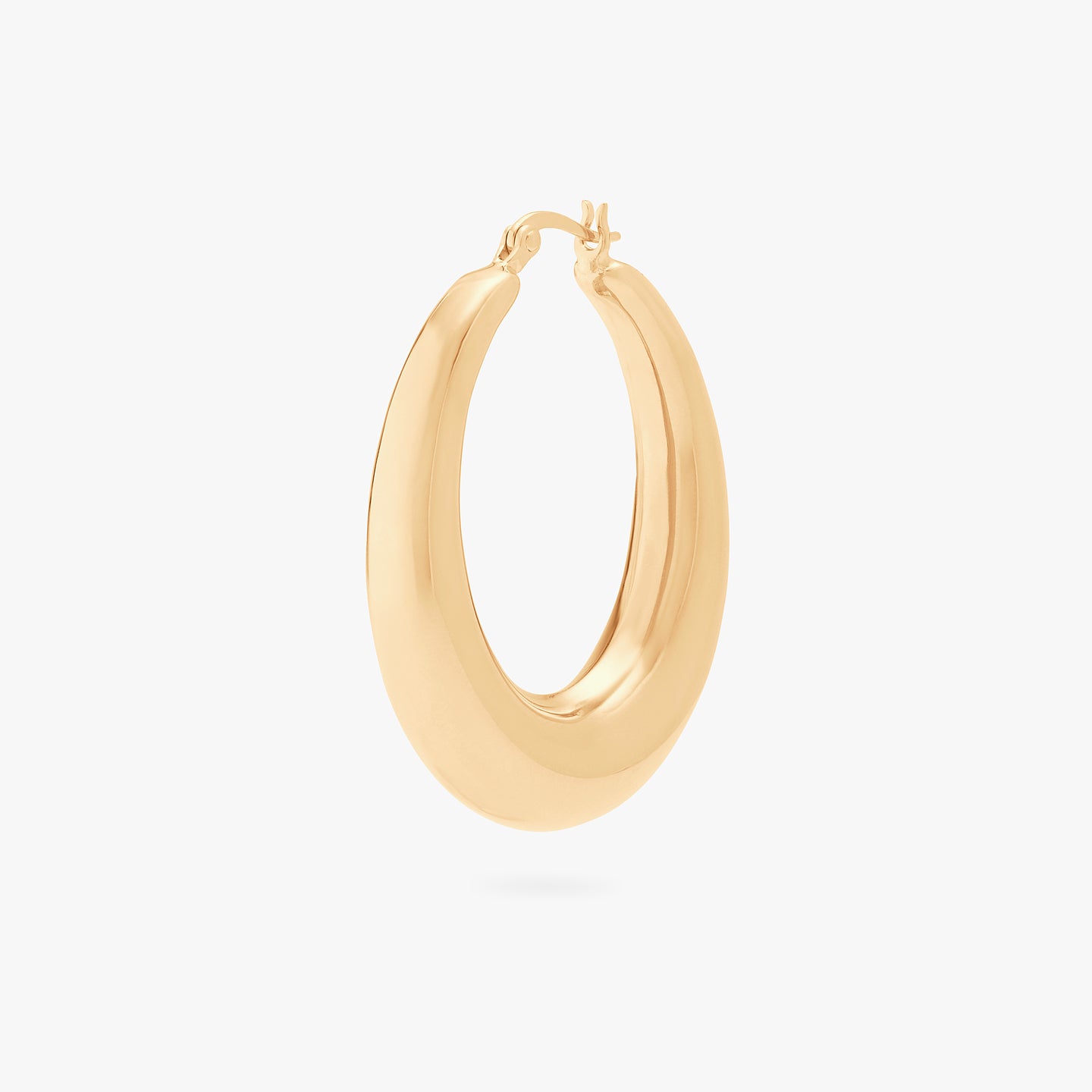This is a gold, large, oval crescent shaped hoop. color:null|gold