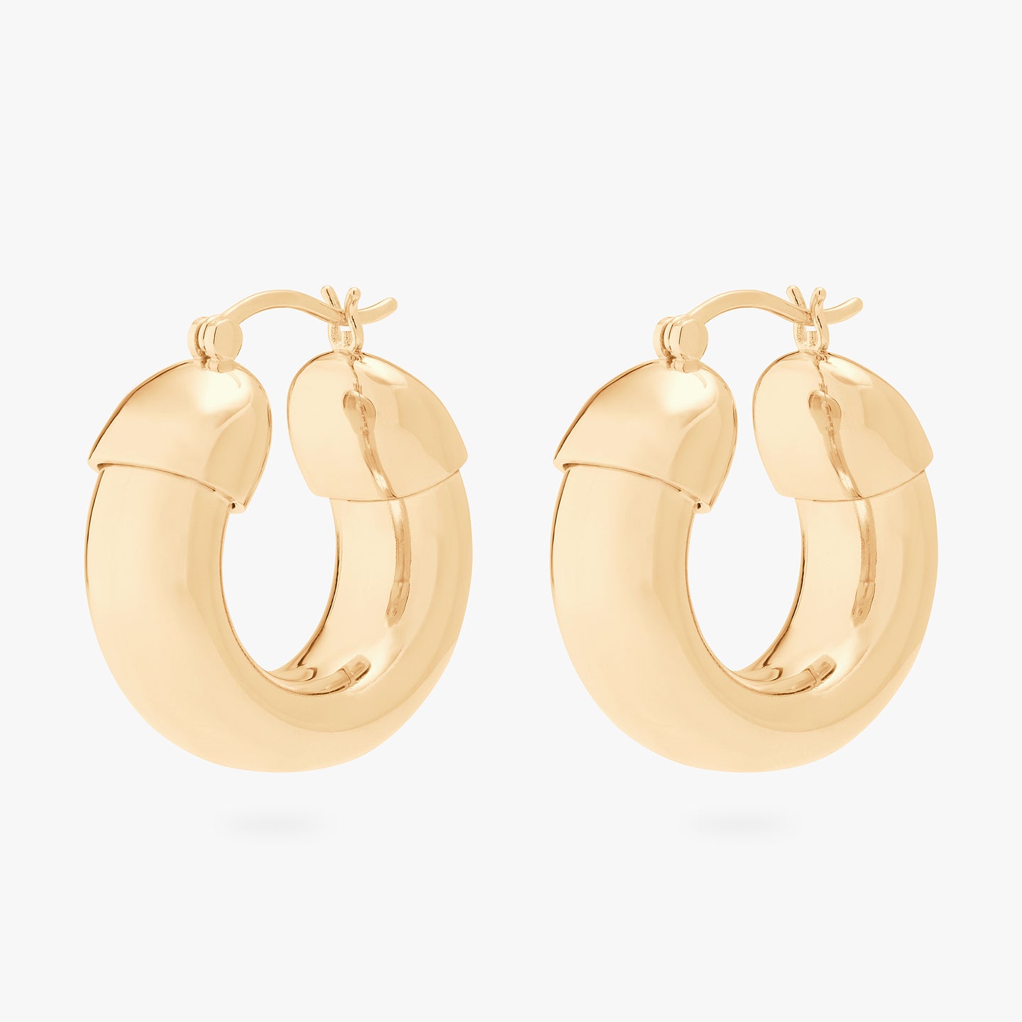 This is an image of a pair of gold, chunky tubed hoops. [pair] color:null|gold