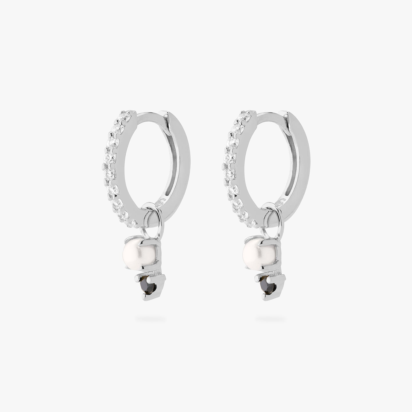 A pair of silver/clear mini pave huggies with a black stacked cz pearl charm. [pair] color:null|silver/black