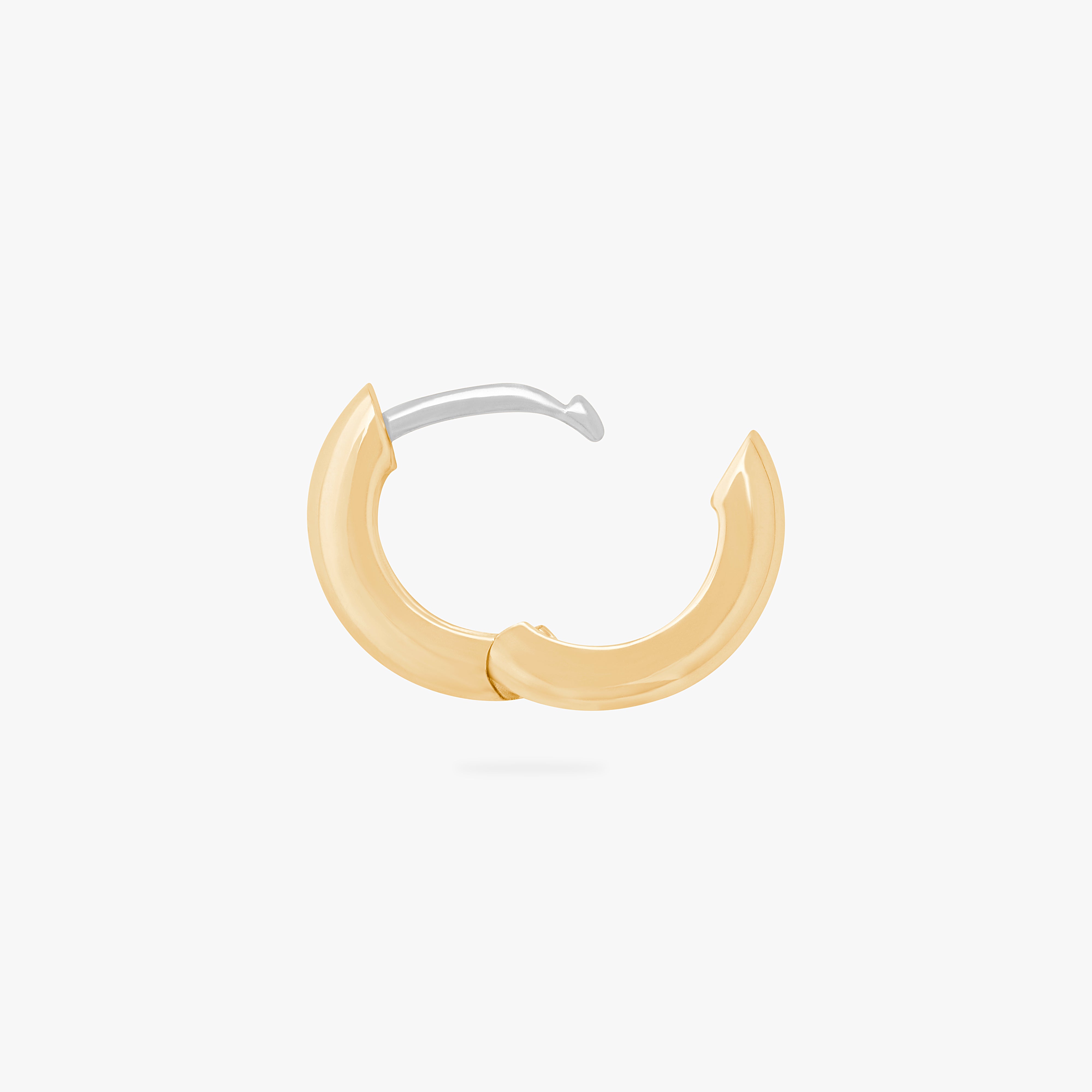 A chunky huggie that is two-toned gold and silver unhinged. color:null|gold/silver