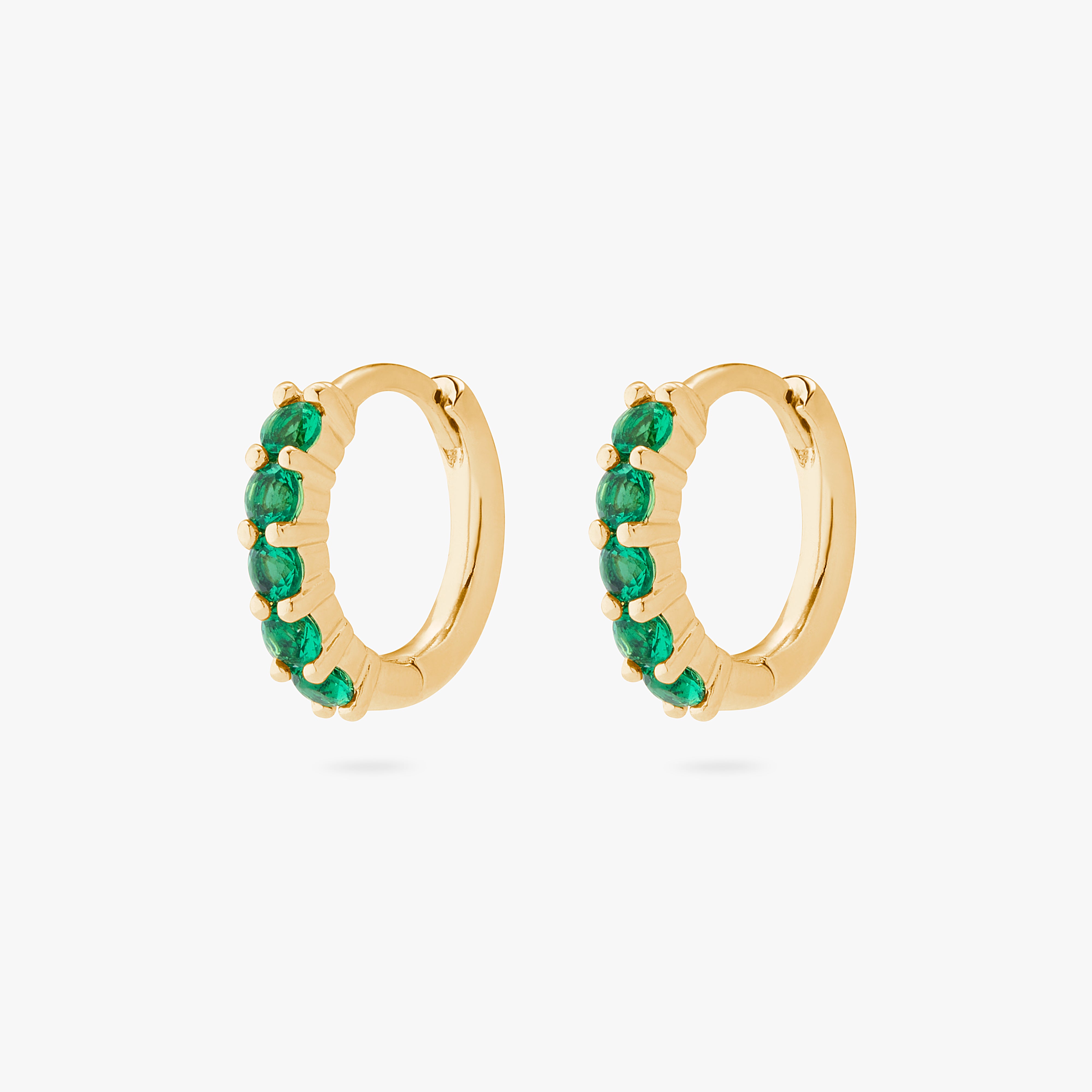 An image of a pair of gold/green pave huggies with max pave stones. [hover]  [pair] color:null|gold/green