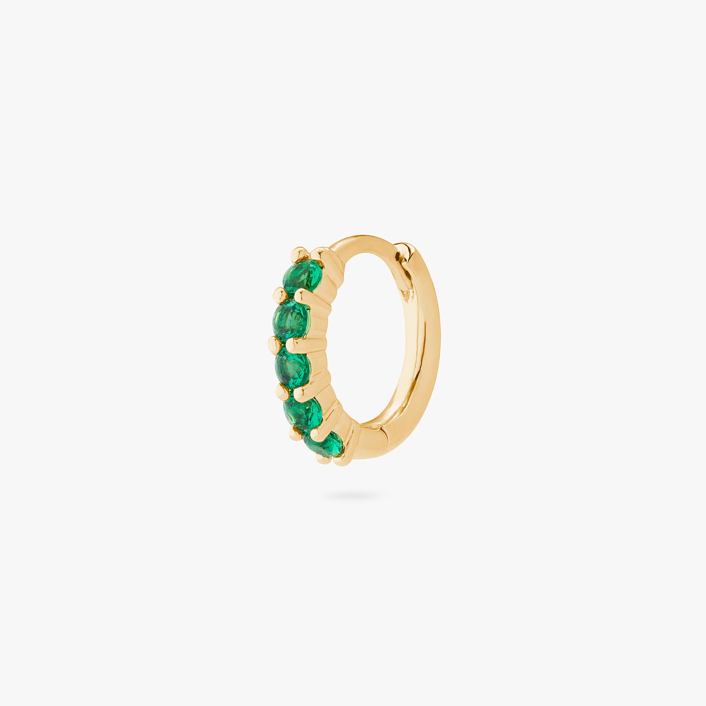 An image of a gold/green pave huggie with max pave stones. color:null|gold/green