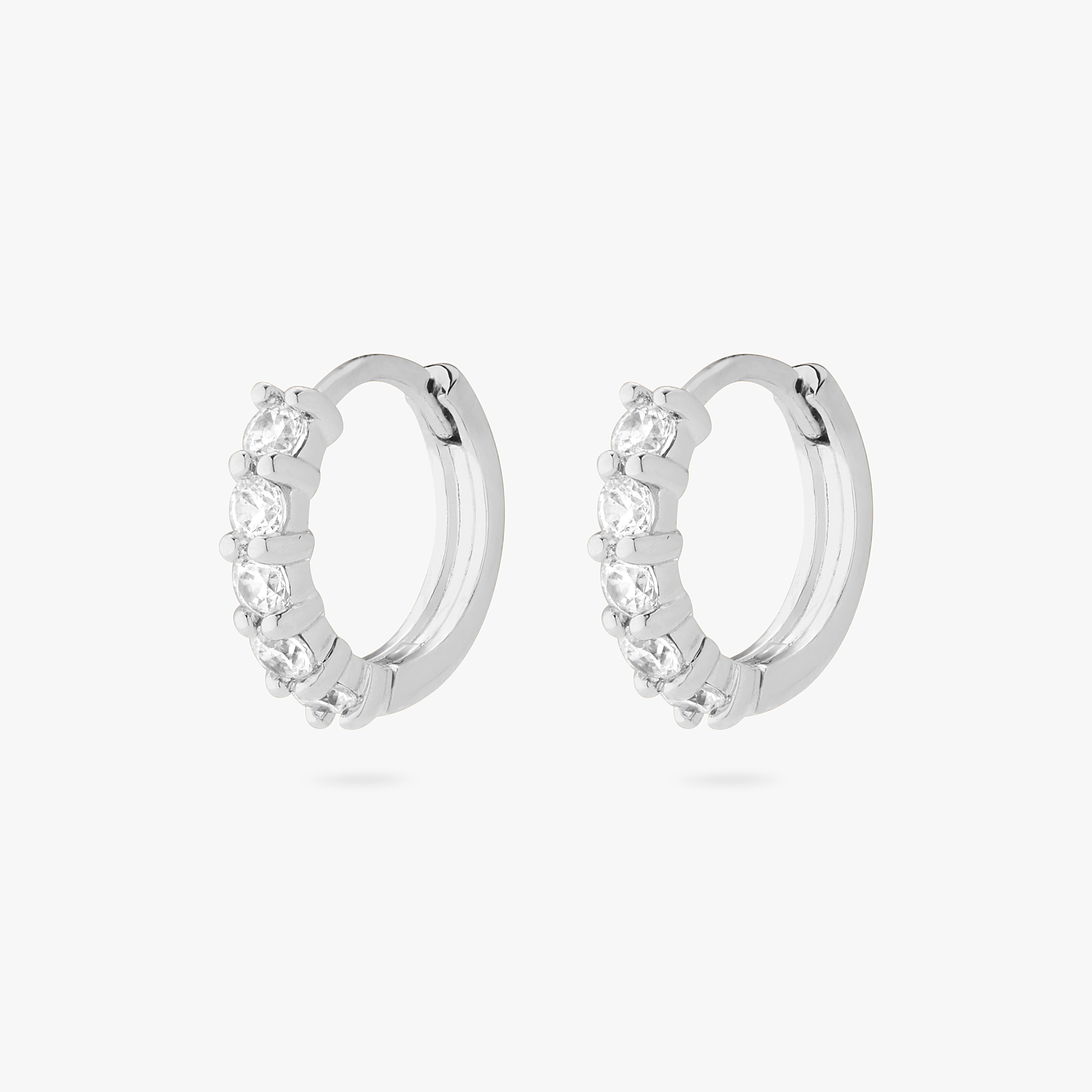 An image of a pair of silver/clear pave huggies with max pave stones. [pair] color:null|silver/clear