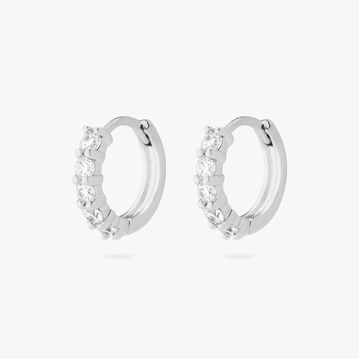 An image of a pair of silver/clear pave huggies with max pave stones. [pair] color:null|silver/clear