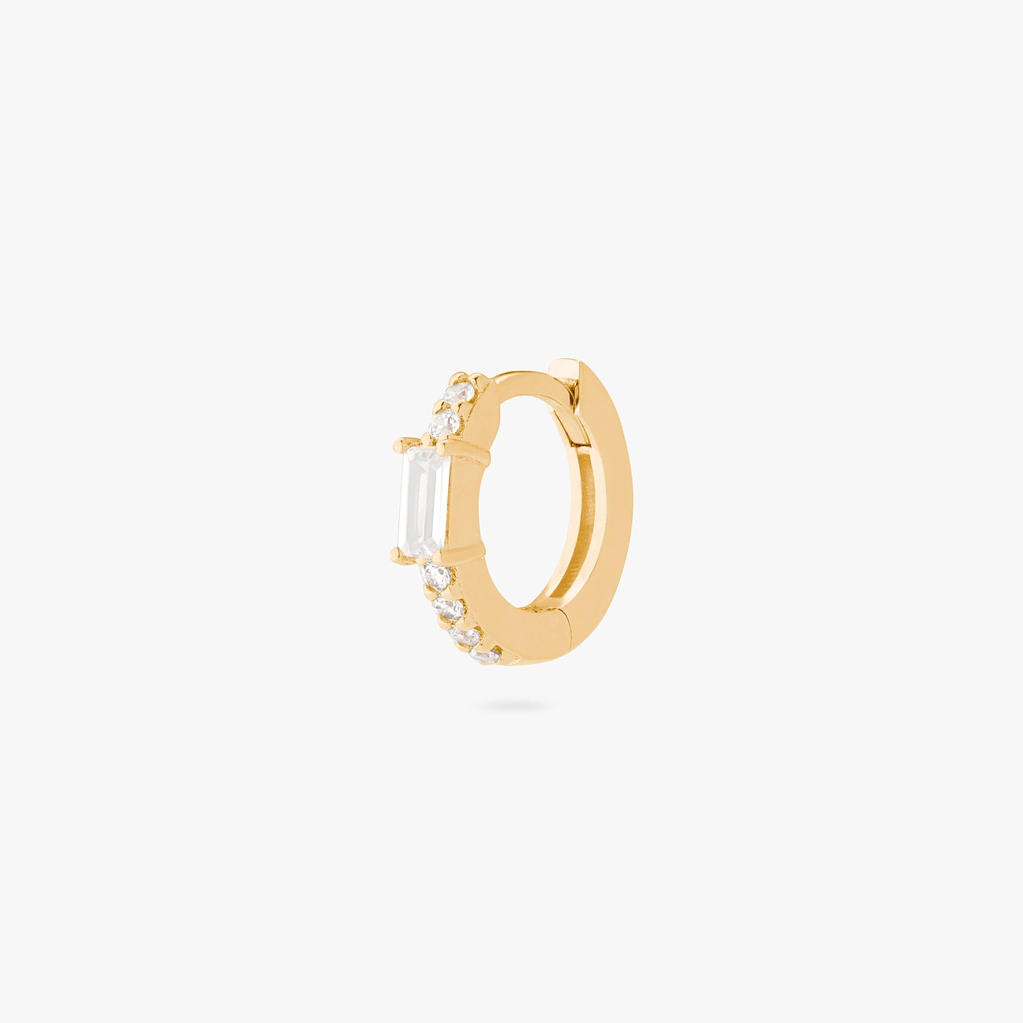 An image of gold/clear huggie with a clear baguette CZ stone. color:null|gold/clear
