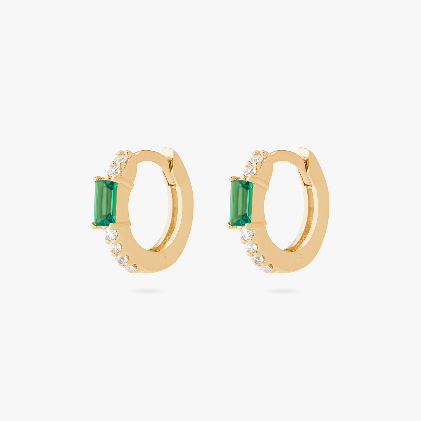 An image of a pair of gold/clear huggies with green accent baguette CZ stones. [pair] color:null|gold/green