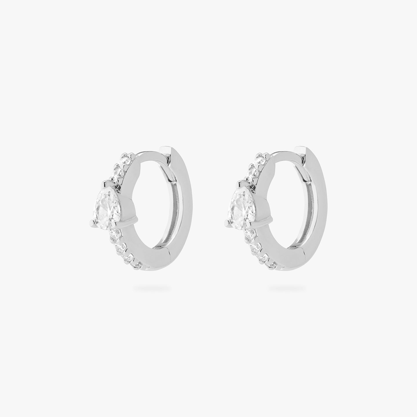 An image of a pair of silver/clear mini pave huggies with a clear pear shaped CZ accent stone. [pair] color:null|silver/clear