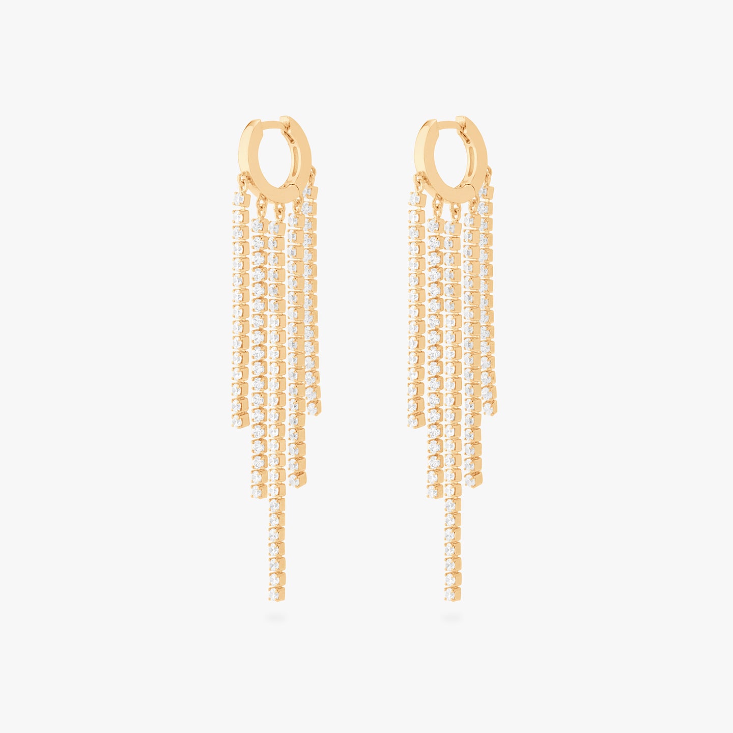 This is an image of a pair of gold huggies that have gold/clear CZ strands dangling from them in a fringed pattern. [pair] color:null|gold/clear