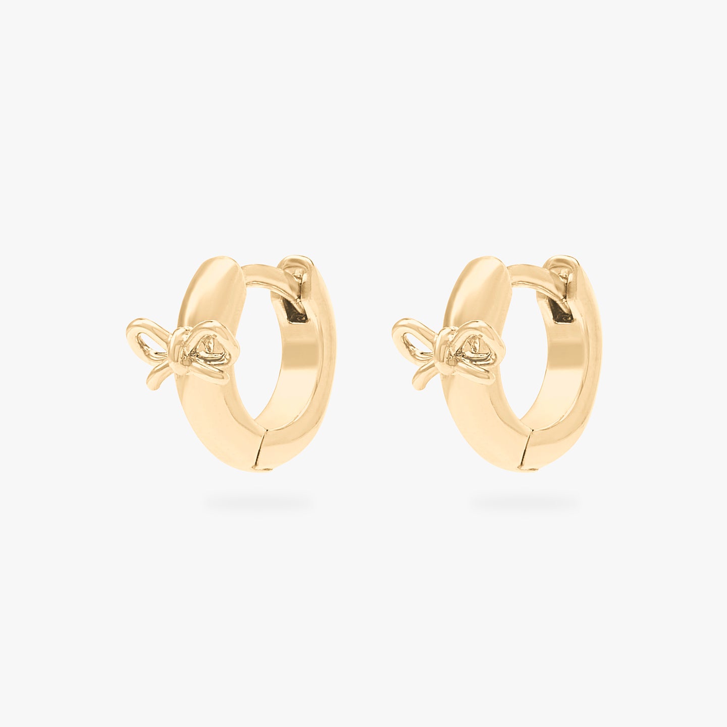 micro huggie with a small bow accent in gold [pair] color:null|gold