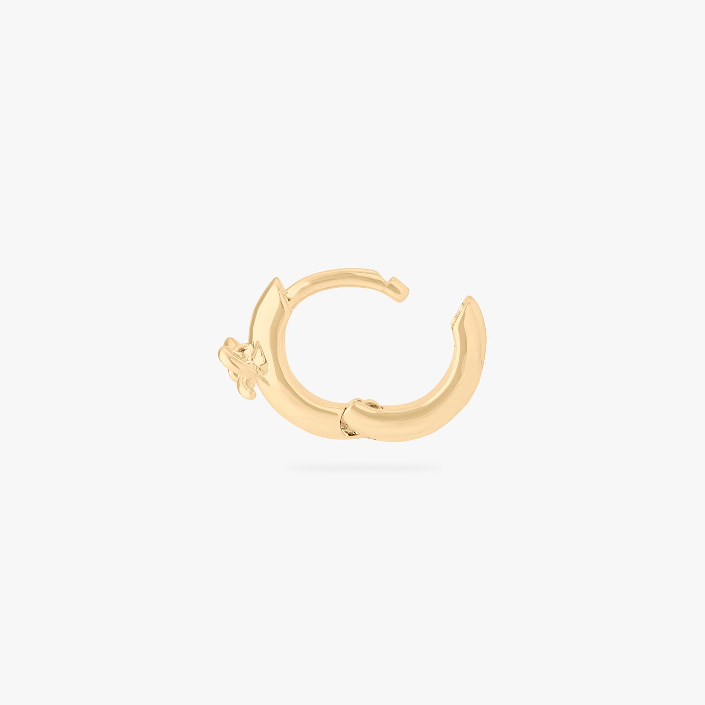 micro huggie with a small bow accent in gold color:null|gold