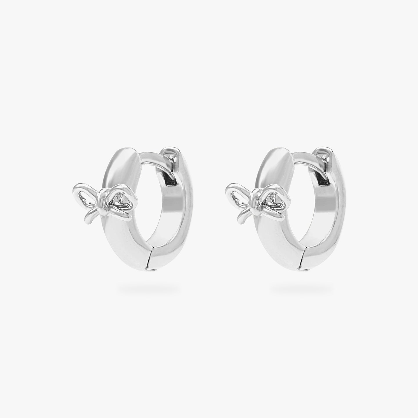 micro huggie with a small bow accent in silver [pair] color:null|silver