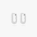 This is an image of a pair of silver-toned, square shaped huggies that have twists throughout them. [pair] color:null|silver