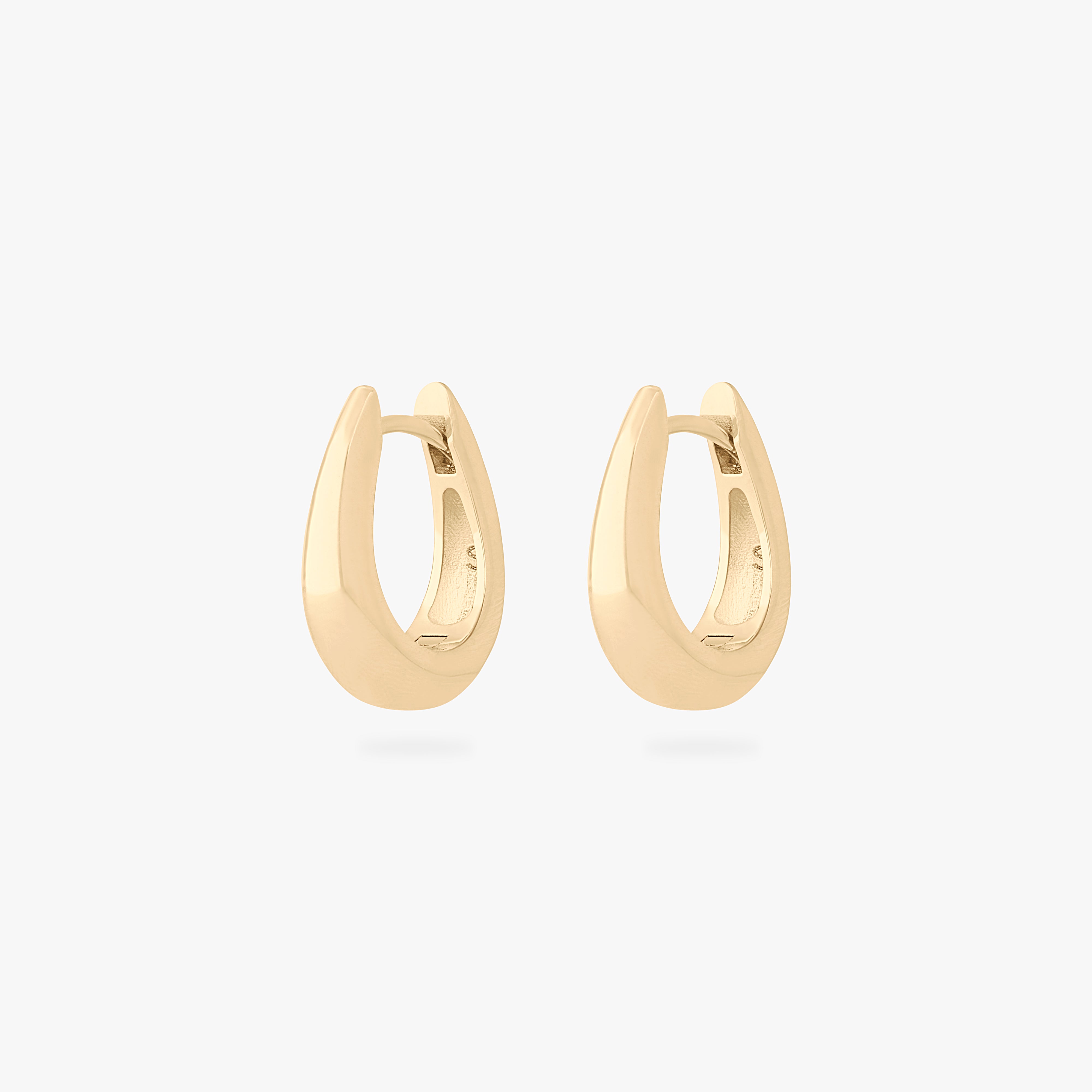 This is an image of a pair of gold-toned, small, crescent shaped huggies. [pair] color:null|gold