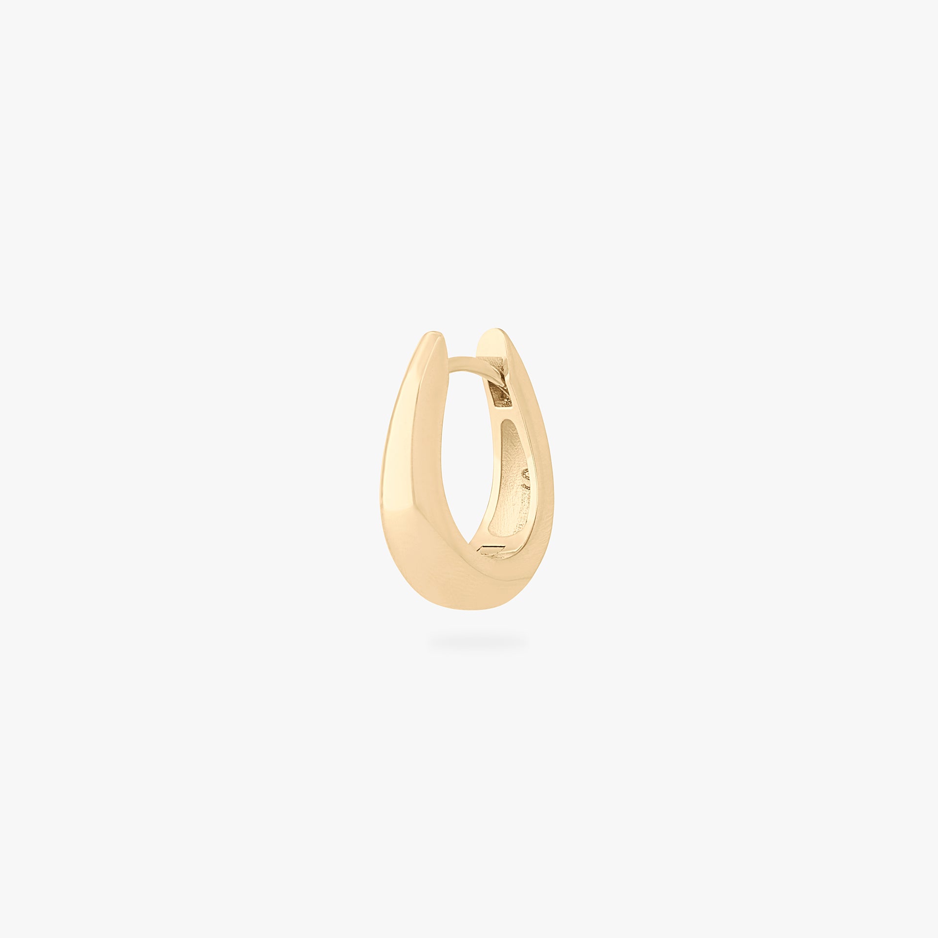 This is an image of a gold-toned, small, crescent shaped huggie. color:null|gold