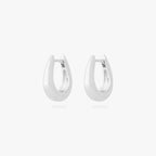 This is an image of a pair of silver-toned, small, crescent shaped huggies. [pair] color:null|silver