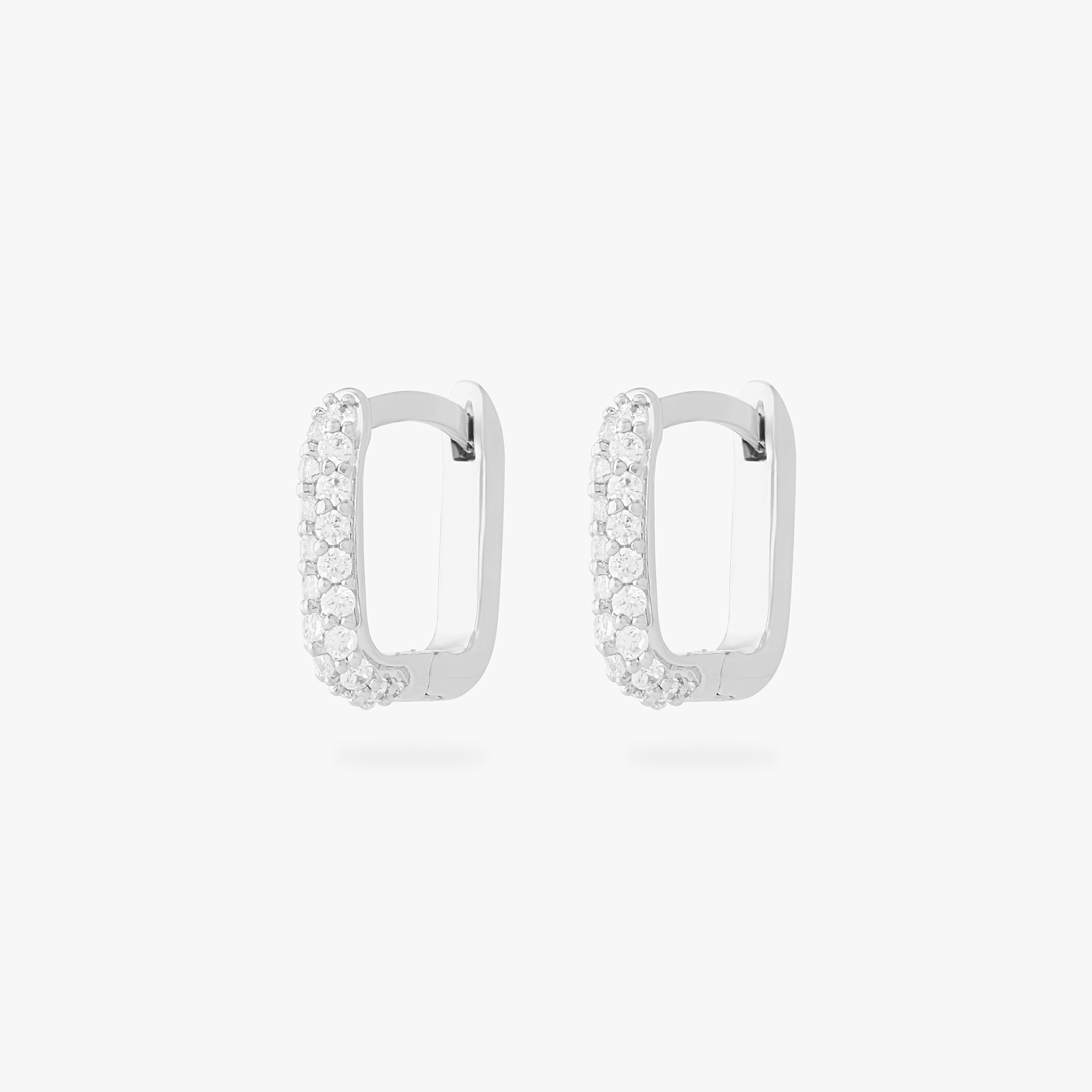 This is an image of a pair of silver-toned, square-shaped huggies with pave CZ stones. [pair] color:null|silver/clear