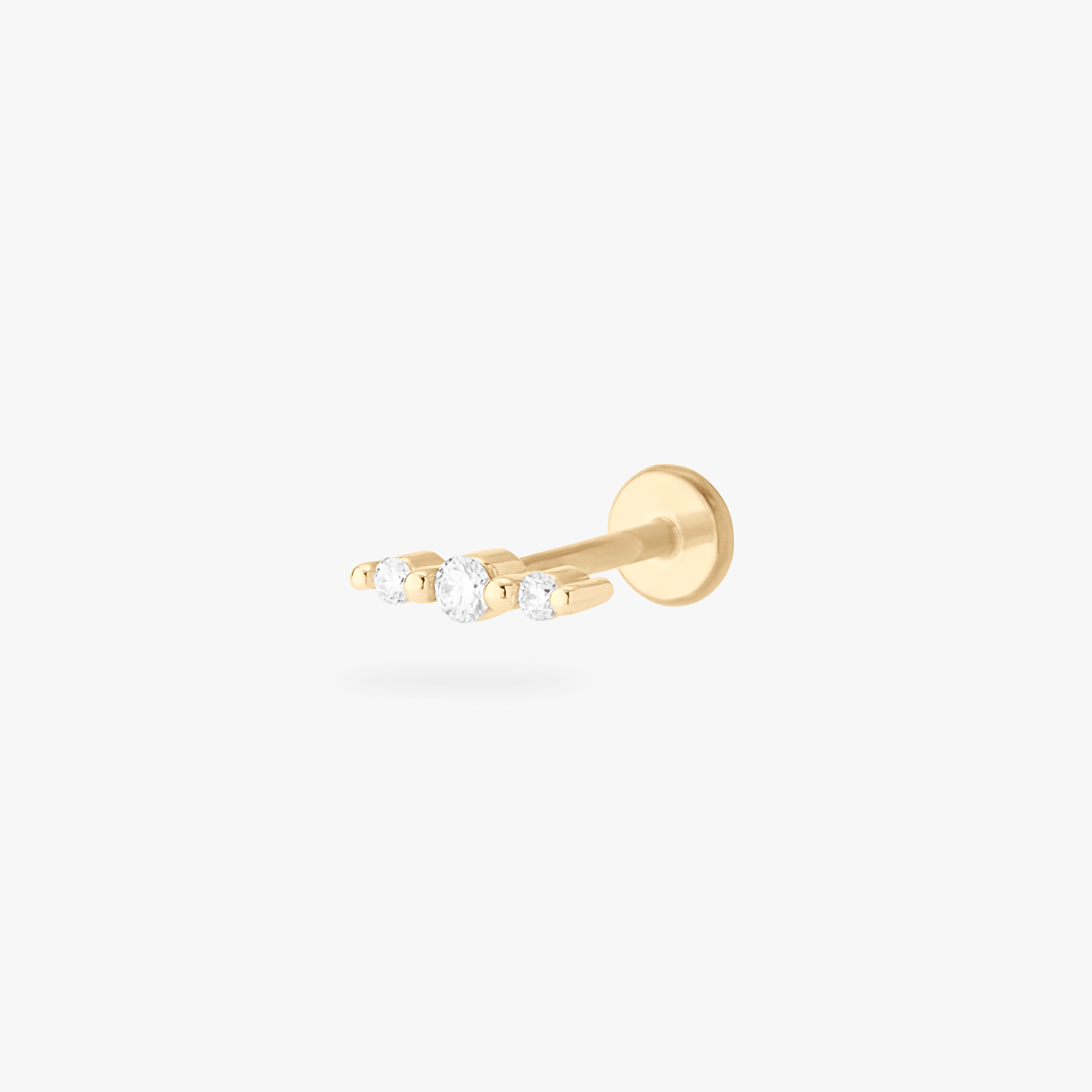 This is an image of a 14k gold flatback with 3 long set diamonds. color:null|gold/clear