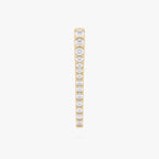 This image shows the front view of the 14k gold plated long pave spike huggie with cz clear stones down the front 
