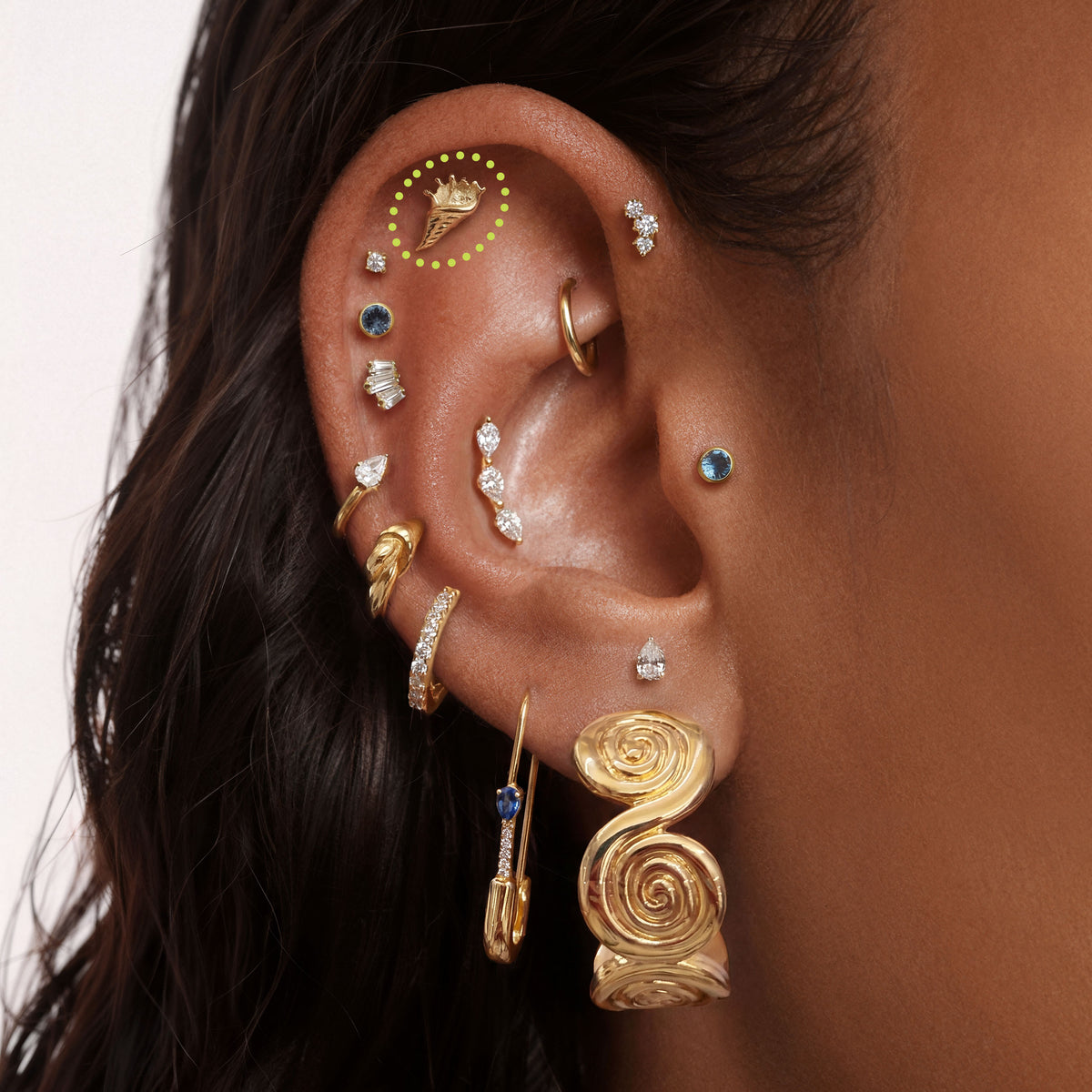 This is a close up image of an ear with a  14k gold conch shell flat back earring 