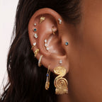 This image shows an ear with a 14k gold plated spiral hoop