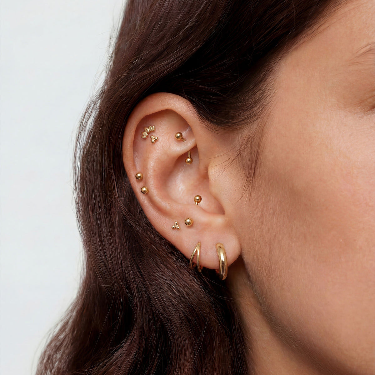 This image shows an earscape featuring the 14k gold solid marquise flatback. 