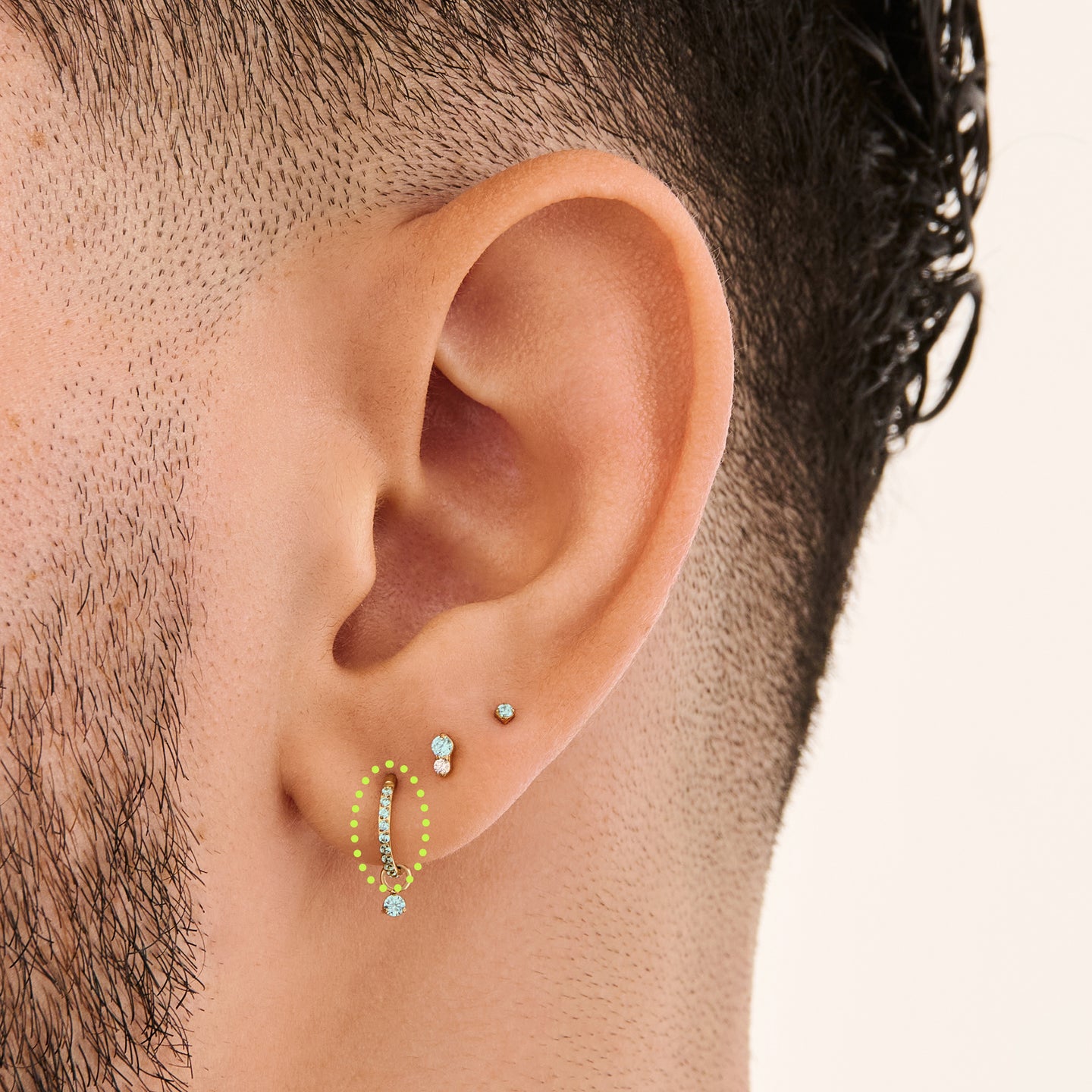 This is a gold toned clicker with aquamarine cz stones on ear. [hover] color:null|aquamarine