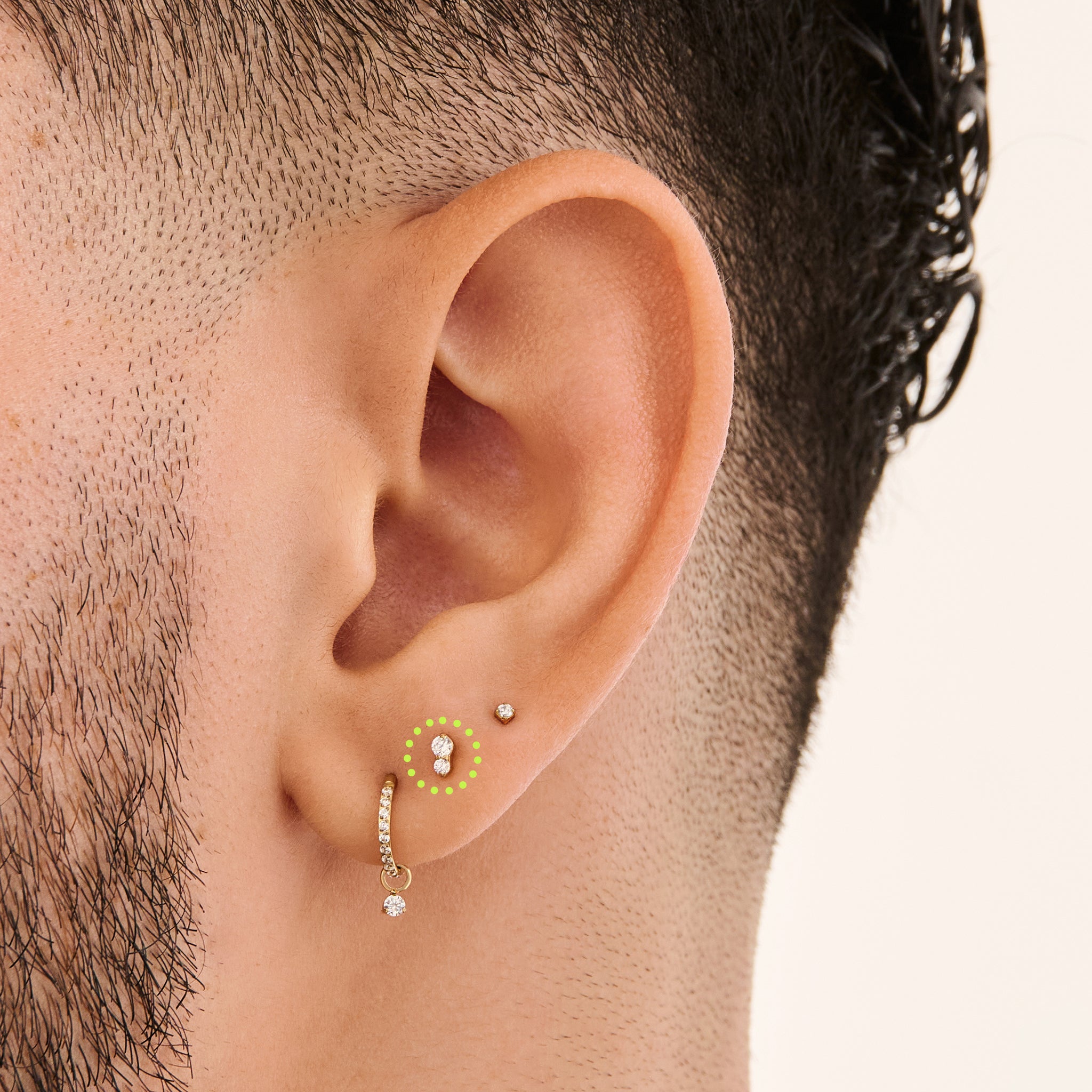 This is a gold flatback stud with a crystal cz stacked over a clear cz on ear. [hover] color:null|crystal|clear