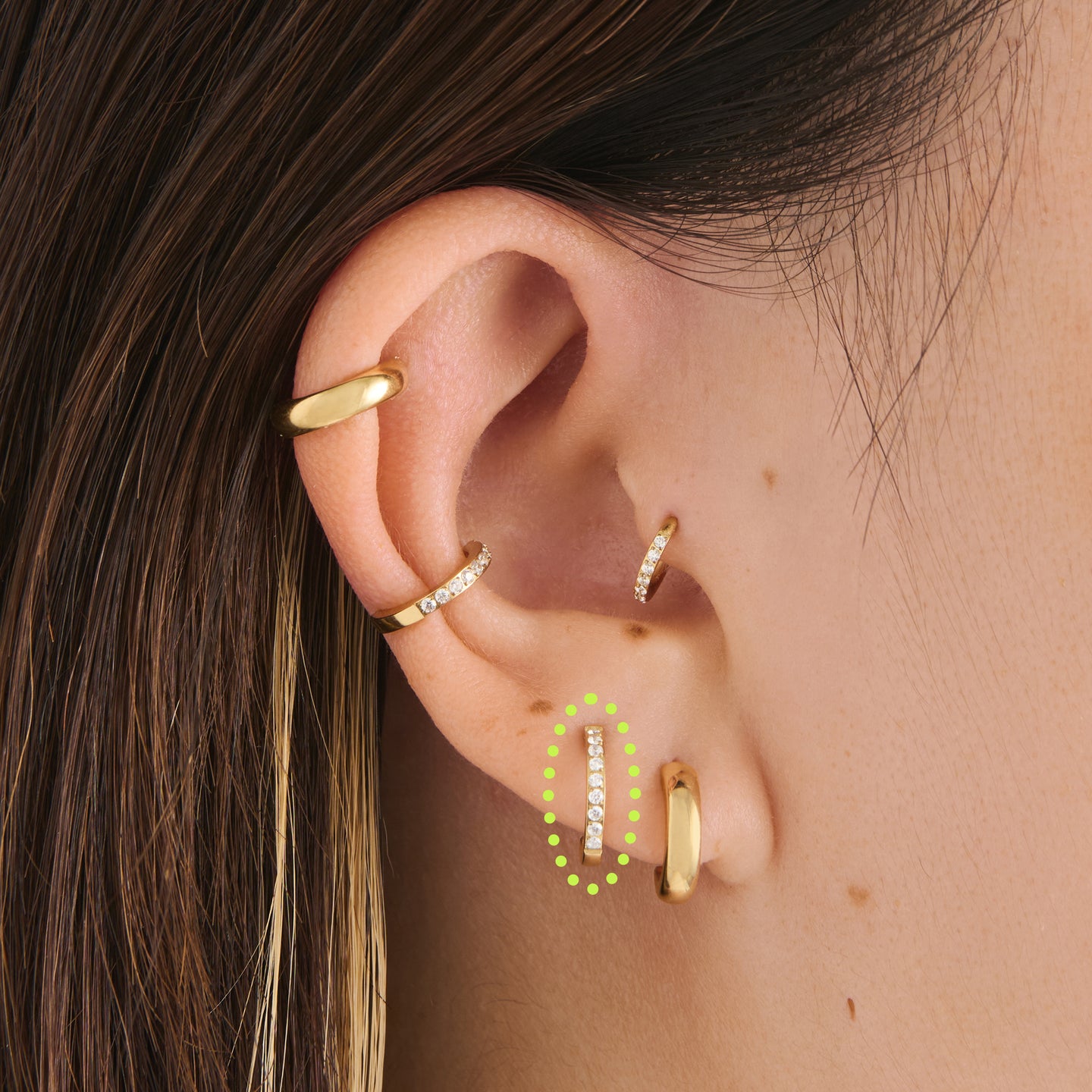 on ear featuring a gold pave flatback huggie with a labret backing with cz accents [hover] color:null|gold