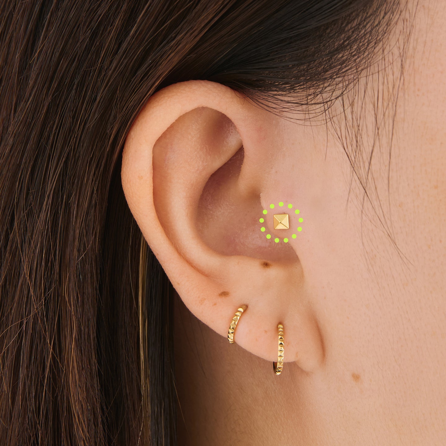 on ear featuring a gold pyramid flatback stud [hover] color:null|gold