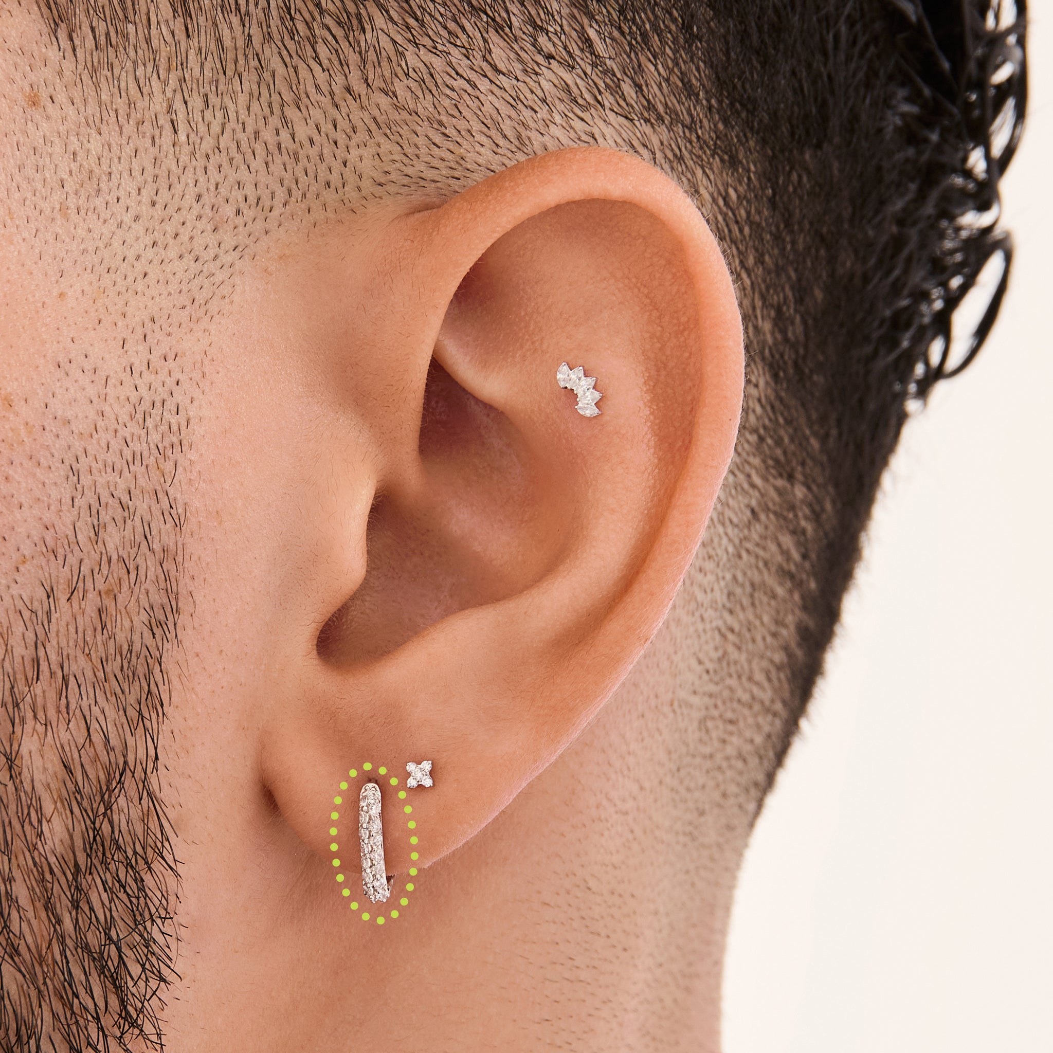 This is an image of a silver-toned, square-shaped huggie with pave CZ stones on ear. [hover] color:null|silver/clear