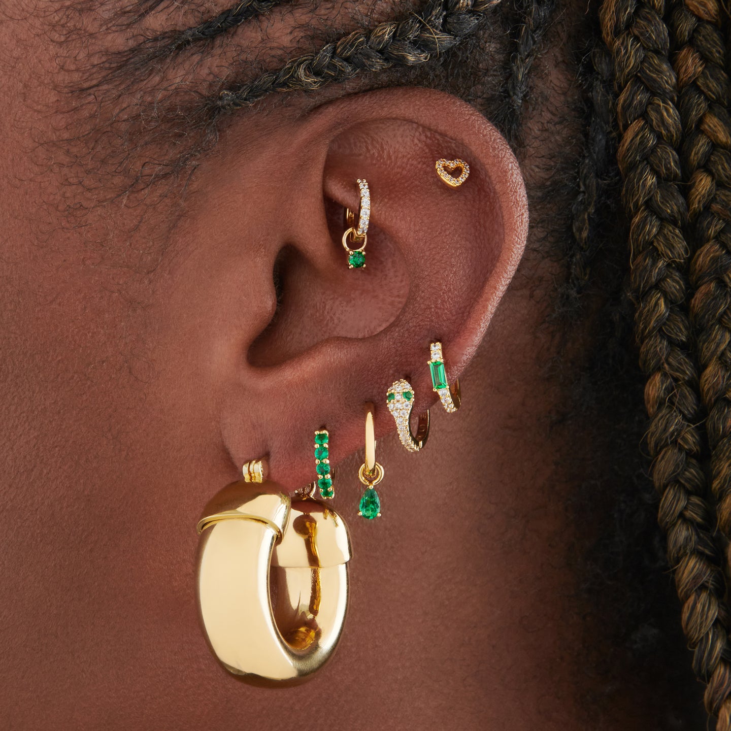 This is an image of a gold, chunky tubed hoop on ear. [hover] color:null|gold