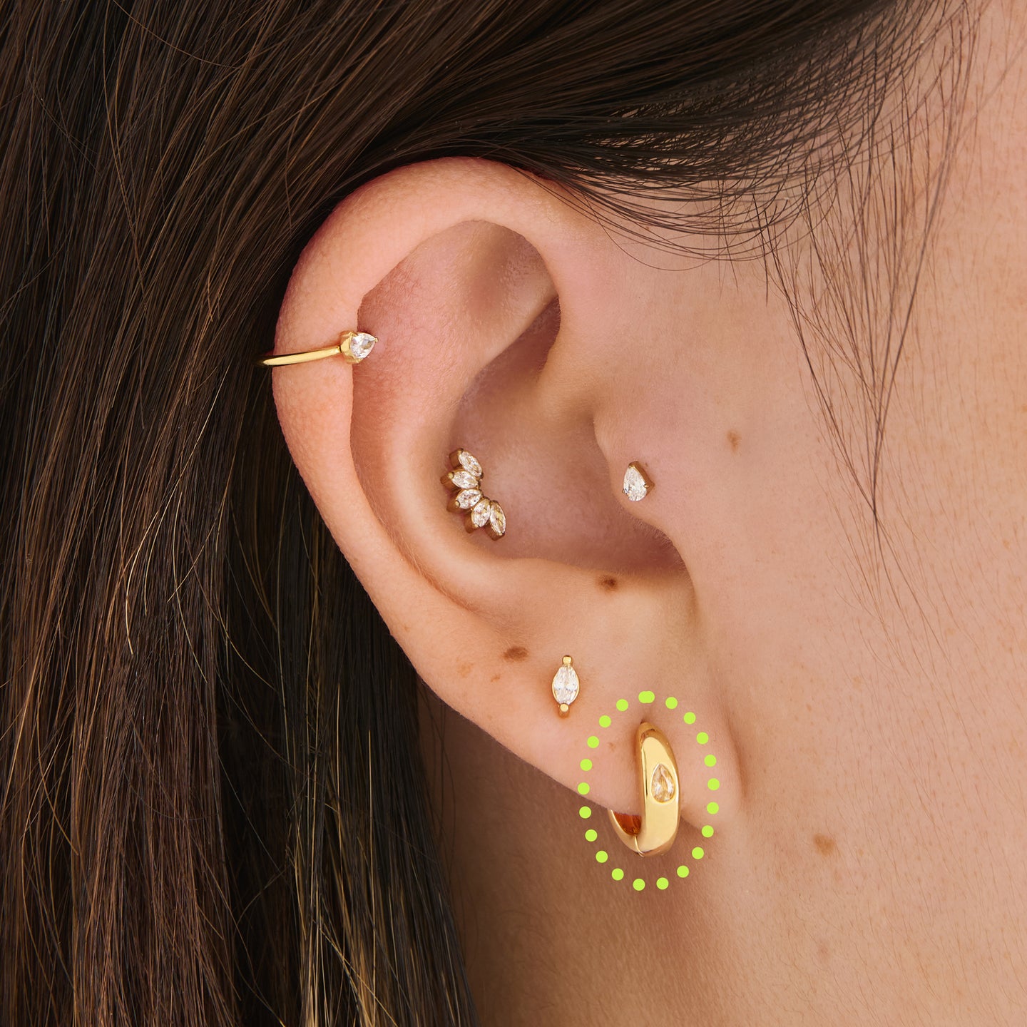 on ear featuring a Chunky huggie featuring a set in pear cz stone in gold [hover] color:null|gold