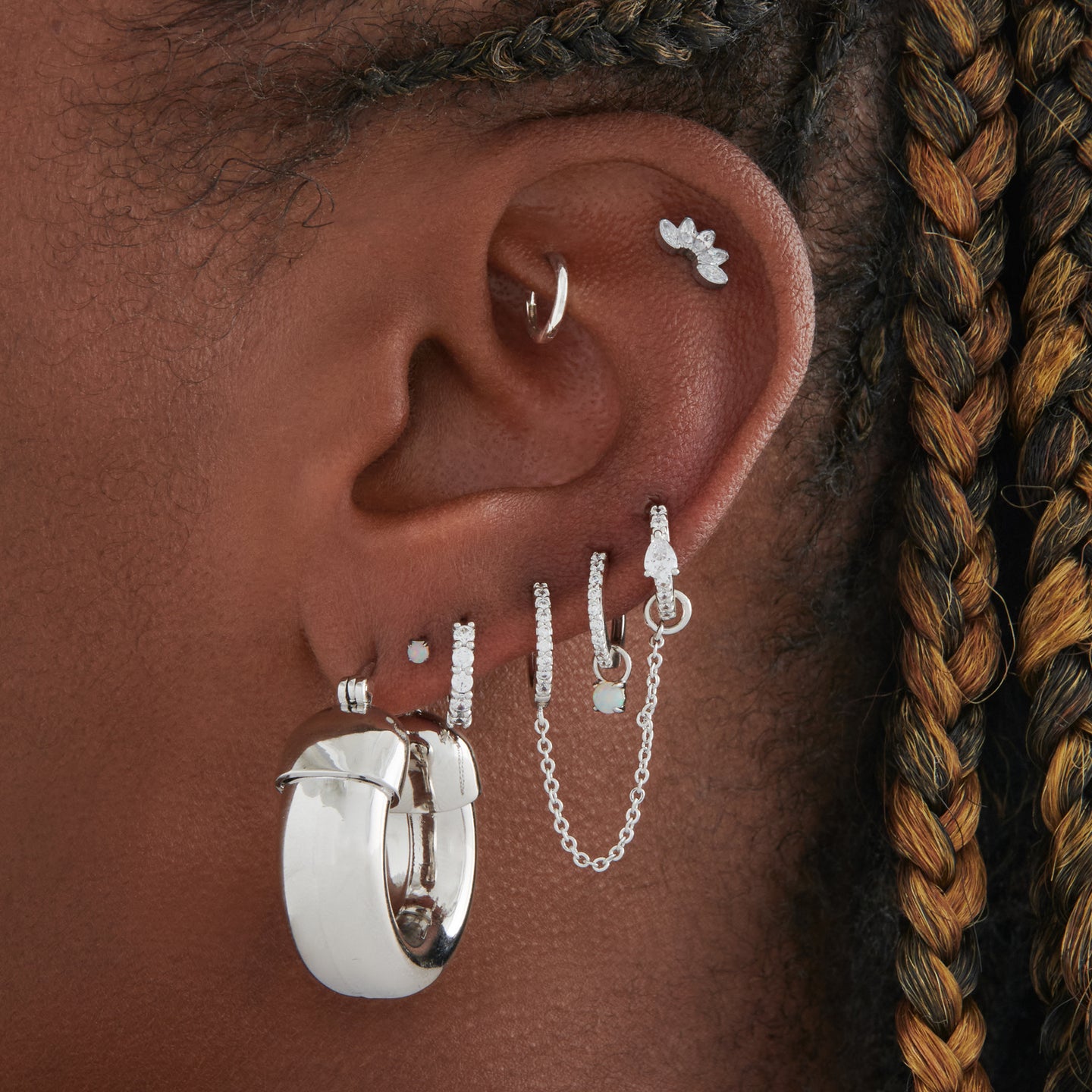 This is an image of a silver, chunky tubed hoop on ear. [hover] color:null|silver
