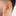 This is an image of a gold-toned, small, crescent shaped huggie on ear. [hover] color:null|gold