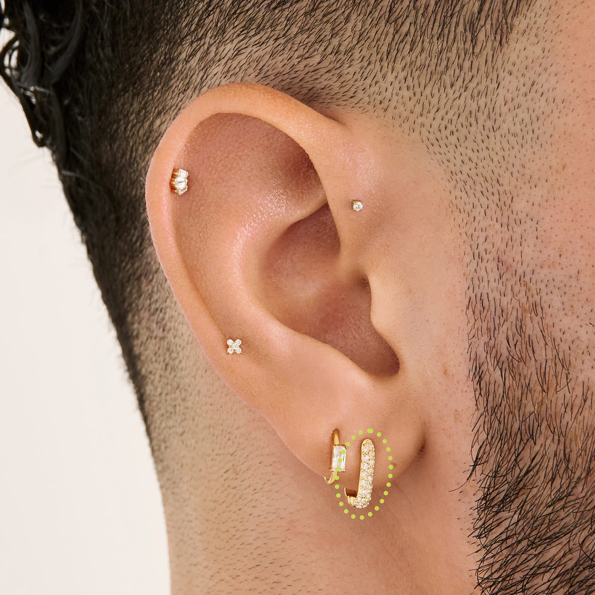 This is an image of a gold-toned, square-shaped huggie with pave CZ stones on ear. [hover] color:null|gold/clear
