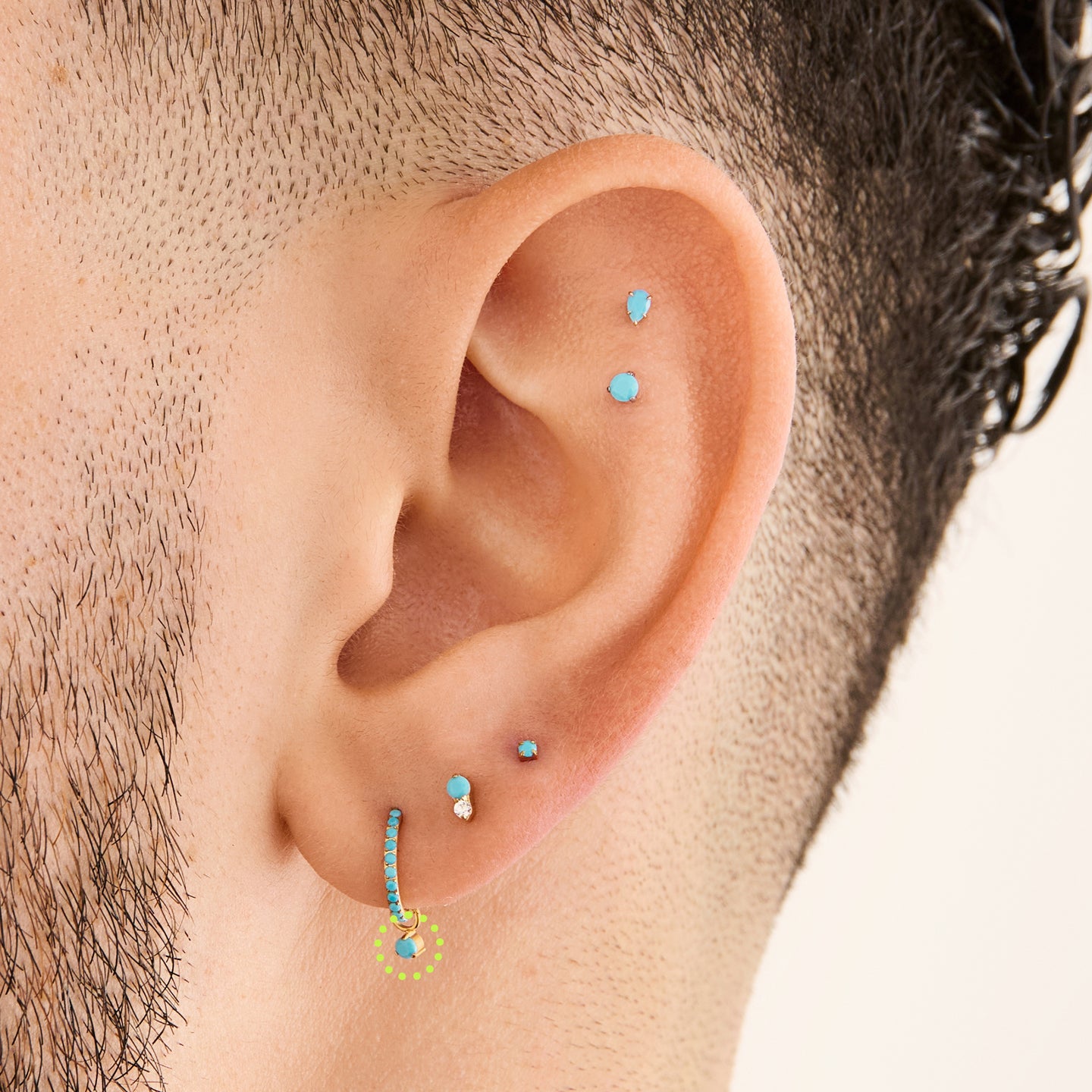 This is an image of a gold charm for a clicker that has a micro turquoise cz on it on ear. [hover] color:null|turquoise