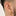 This is an image of a gold-toned huggie that is chunky with CZs encrusted in it on ear. [hover] color:null|gold/clear