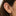 This is an image of a 14k gold flatback stud that has a clear lab-grown diamond with round prongs on ear. [hover] color:null|gold/clear