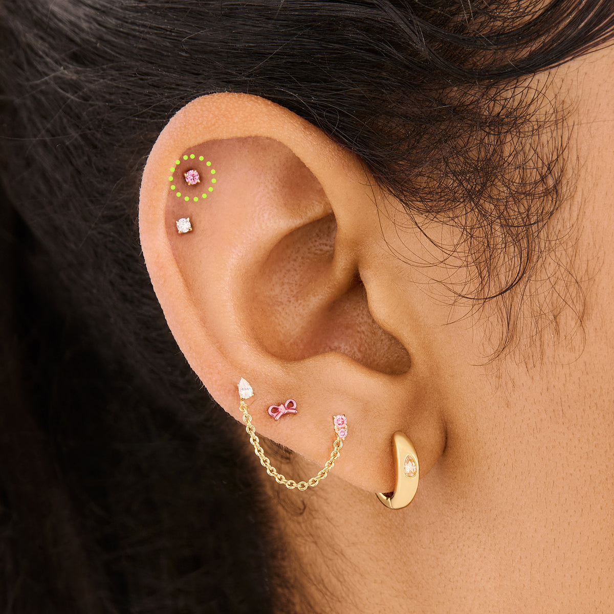 This image shows a flatback stud made of 14K gold with a round pink diamond stone circled on ear. 