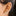 This is an image of a silver-toned huggie that is chunky with CZs encrusted in it on ear. [hover] color:null|silver/clear