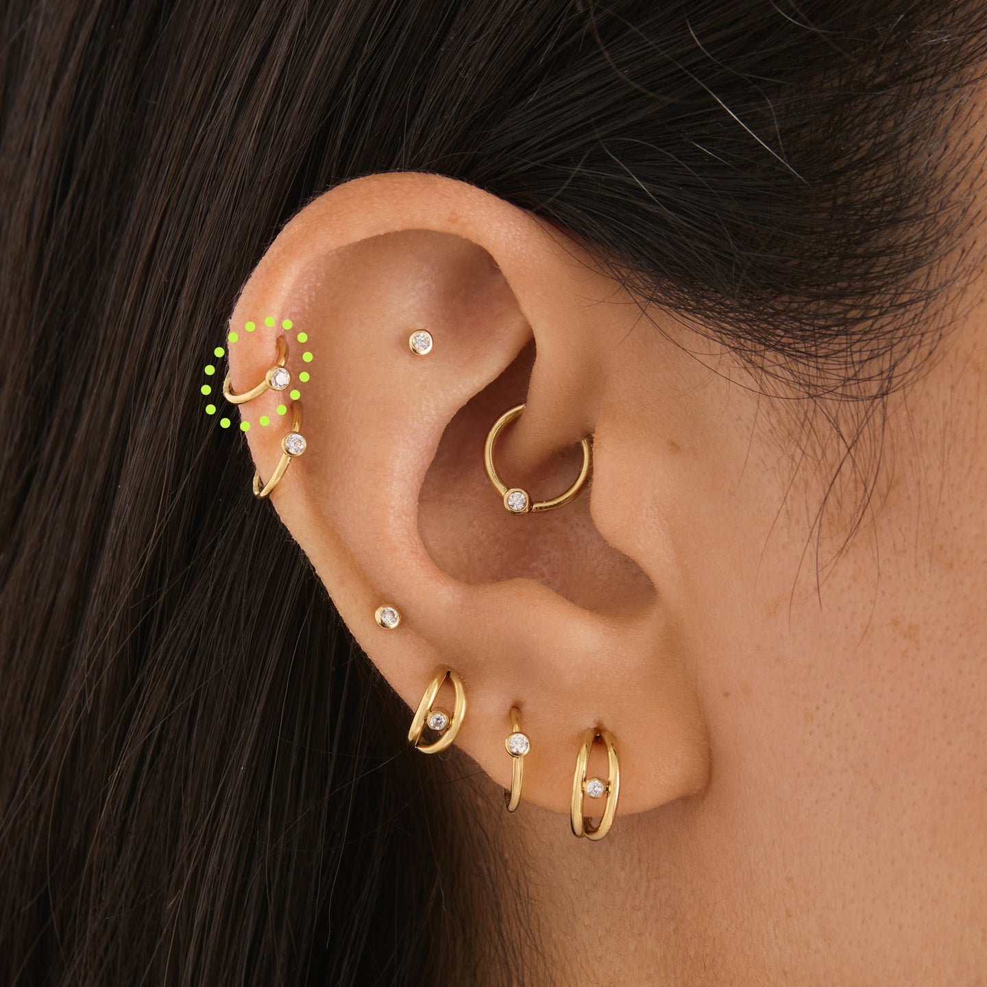 on ear featuring a gold 6mm clicker with a clear bezel cz accent [hover] color:null|gold/clear